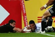 Samoa's Lio Lolo (R) scores a try despite New Zeland's Kurt Baker